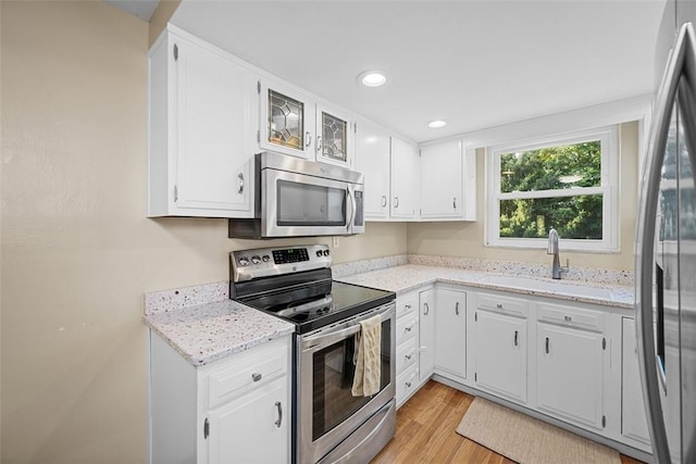 723 Rose Ln, Baldwin Twp, PA 15234 - kitchen featuring stainless steel appliances, light wood-style flooring, white cabinetry, light stone counters, and recessed lighting