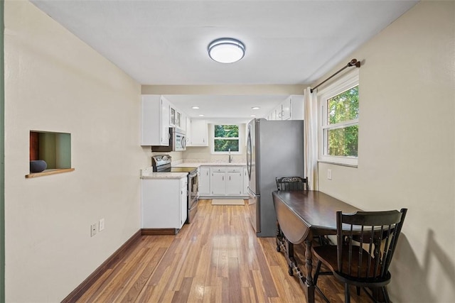 723 Rose Ln, Baldwin Twp, PA 15234 - kitchen with appliances with stainless steel finishes, light wood-style flooring, white cabinets, and recessed lighting