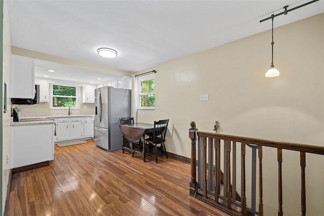 723 Rose Ln, Baldwin Twp, PA 15234 - kitchen with stainless steel fridge, wood-type flooring, white cabinetry, light countertops, and healthy amount of natural light