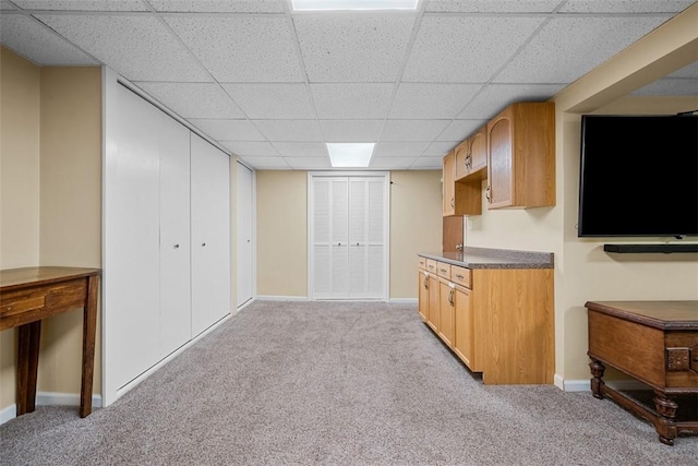 723 Rose Ln, Baldwin Twp, PA 15234 - kitchen with a paneled ceiling, light colored carpet, and dark countertops