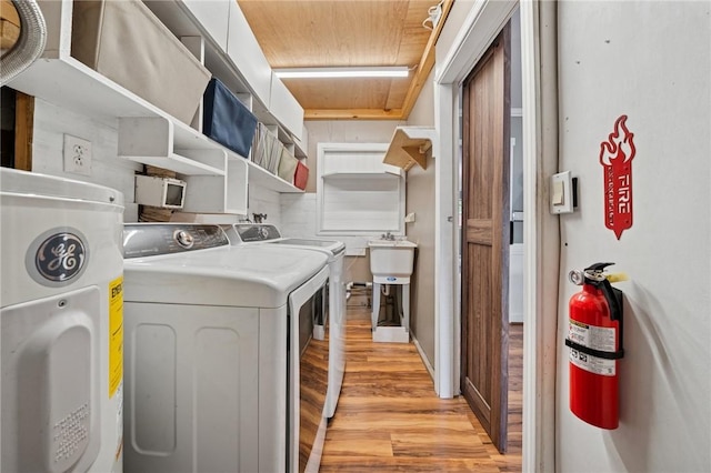 213 Mcdonald Dr, North Huntingdon, PA 15642 - laundry area featuring washing machine and clothes dryer, light wood finished floors, and water heater