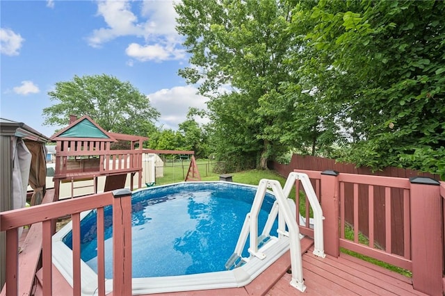 213 Mcdonald Dr, North Huntingdon, PA 15642 - view of pool featuring a fenced backyard, a playground, and a deck