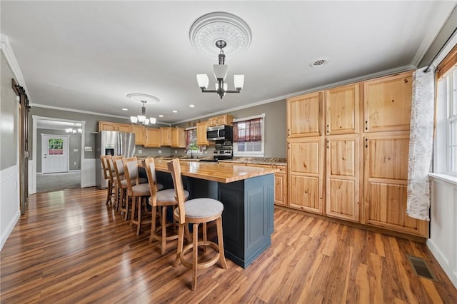 213 Mcdonald Dr, North Huntingdon, PA 15642 - kitchen with a chandelier, appliances with stainless steel finishes, healthy amount of natural light, light wood-style flooring, and crown molding