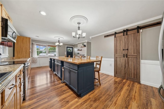 213 Mcdonald Dr, North Huntingdon, PA 15642 - kitchen with a chandelier, stainless steel appliances, a barn door, crown molding, and a kitchen bar