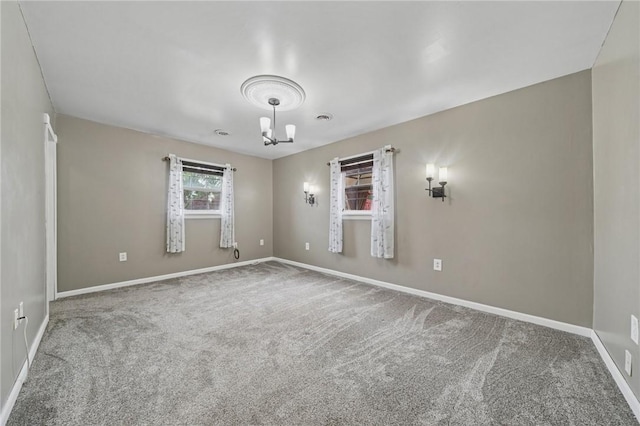 213 Mcdonald Dr, North Huntingdon, PA 15642 - carpeted empty room with a chandelier and baseboards