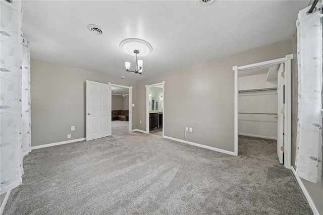 213 Mcdonald Dr, North Huntingdon, PA 15642 - unfurnished bedroom featuring a walk in closet, a chandelier, carpet floors, and ensuite bathroom
