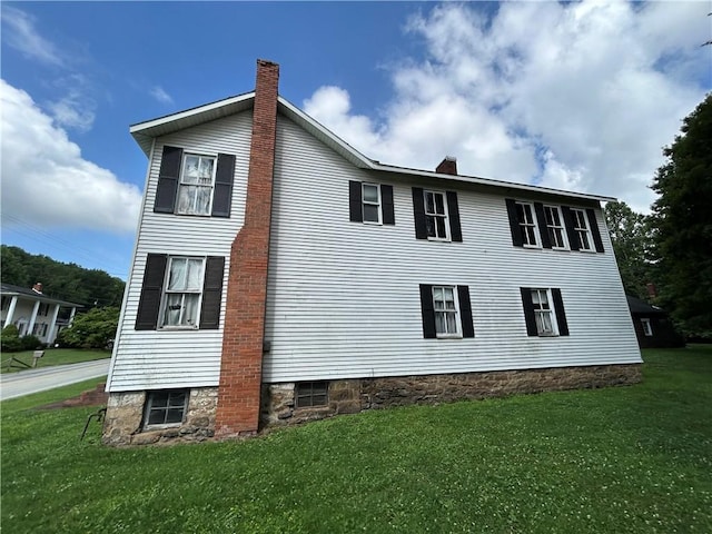 653 Upr Middletown Rd, Menallen Twp, PA 15480 - view of home's exterior with a chimney and a lawn