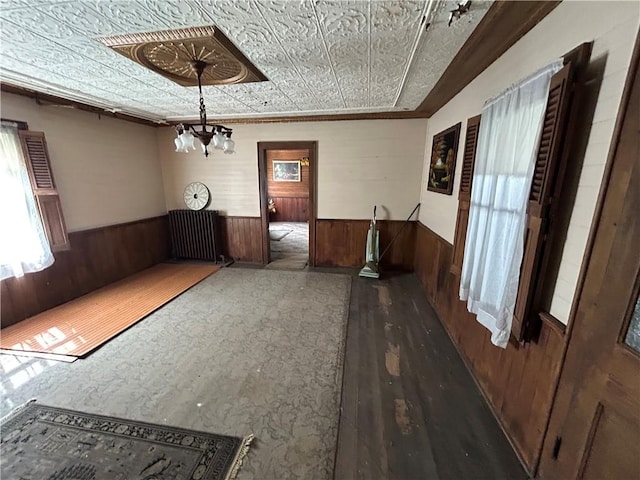 653 Upr Middletown Rd, Menallen Twp, PA 15480 - unfurnished dining area featuring a wainscoted wall, wood walls, wood finished floors, a chandelier, and an ornate ceiling