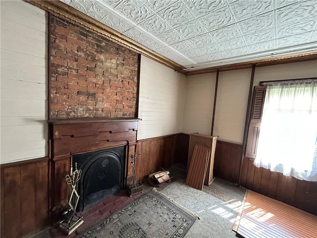 653 Upr Middletown Rd, Menallen Twp, PA 15480 - unfurnished living room featuring wood walls, a fireplace, wainscoting, an ornate ceiling, and crown molding