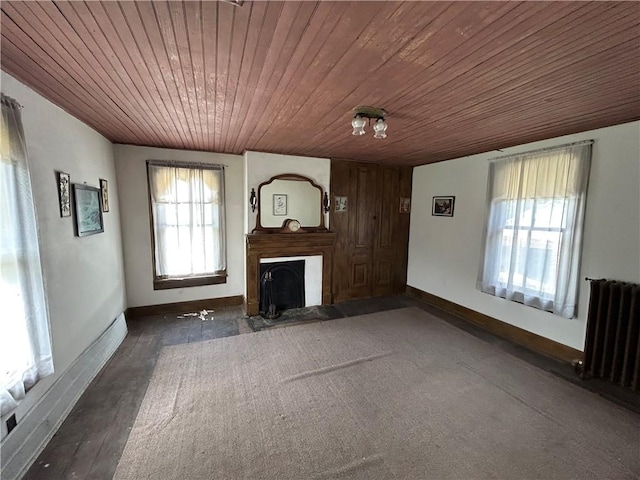 653 Upr Middletown Rd, Menallen Twp, PA 15480 - unfurnished living room featuring radiator heating unit, wooden ceiling, and a fireplace with flush hearth