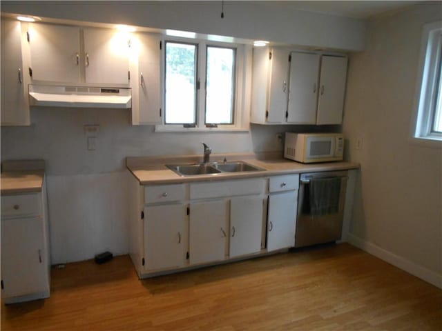 321 E 4th St, Derry Twp, PA 15627 - kitchen with white microwave, under cabinet range hood, stainless steel dishwasher, white cabinets, and light wood finished floors