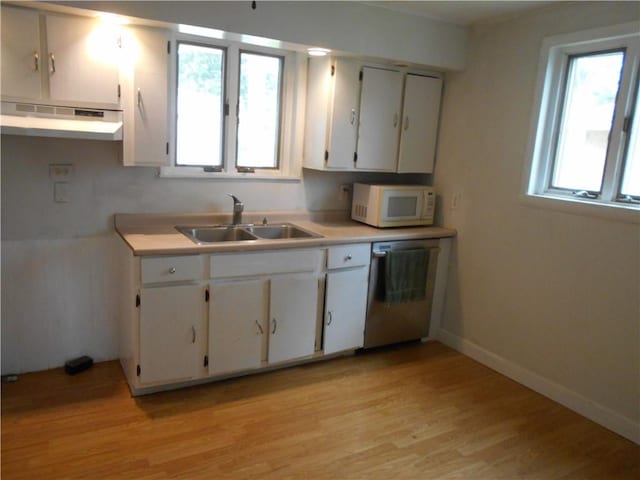 321 E 4th St, Derry Twp, PA 15627 - kitchen with white microwave, dishwasher, light wood-style flooring, under cabinet range hood, and white cabinets