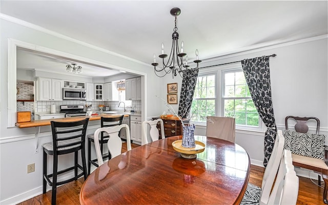 2712 Champlain, Shaler, PA 15101 - dining room featuring crown molding, a chandelier, and dark wood-style floors