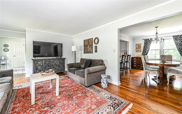 2712 Champlain, Shaler, PA 15101 - living room featuring ornamental molding, wood finished floors, and a chandelier