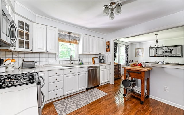 2712 Champlain, Shaler, PA 15101 - kitchen featuring appliances with stainless steel finishes, a chandelier, backsplash, and white cabinetry