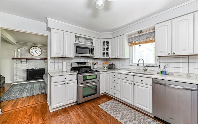2712 Champlain, Shaler, PA 15101 - kitchen featuring stainless steel appliances, dark wood-type flooring, white cabinetry, backsplash, and light countertops