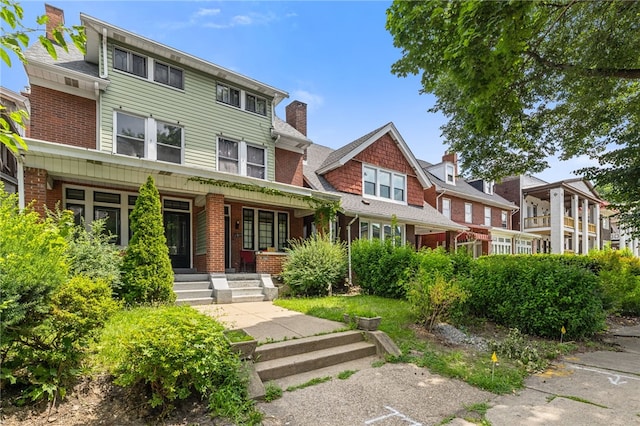 6933 Mcpherson Blvd, Point Breeze, PA 15208 - view of front facade featuring a porch, a chimney, and brick siding