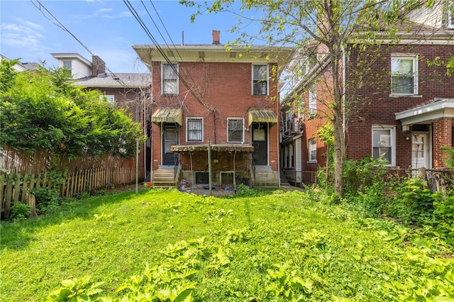 6933 Mcpherson Blvd, Point Breeze, PA 15208 - rear view of property featuring brick siding, entry steps, and a chimney