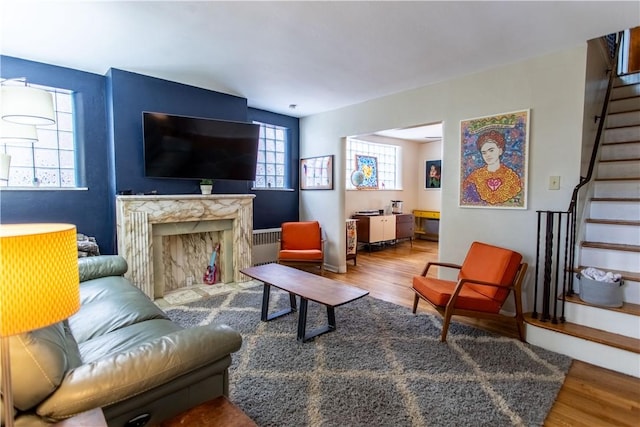 5553 Pocusset St, Squirrel Hill, PA 15217 - living area with wood finished floors, stairs, and a fireplace