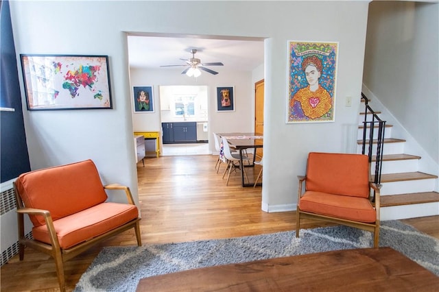 5553 Pocusset St, Squirrel Hill, PA 15217 - living area with light wood-style flooring, stairway, and a ceiling fan