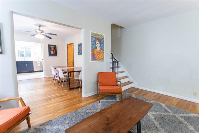 5553 Pocusset St, Squirrel Hill, PA 15217 - sitting room with wood finished floors, stairway, and a ceiling fan