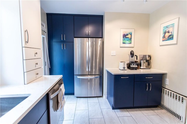 5553 Pocusset St, Squirrel Hill, PA 15217 - kitchen featuring appliances with stainless steel finishes, blue cabinetry, radiator heating unit, and light tile patterned floors