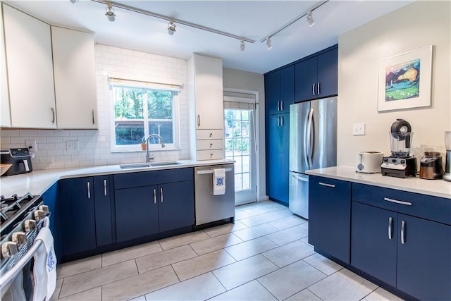 5553 Pocusset St, Squirrel Hill, PA 15217 - kitchen with blue cabinetry, appliances with stainless steel finishes, track lighting, and light countertops