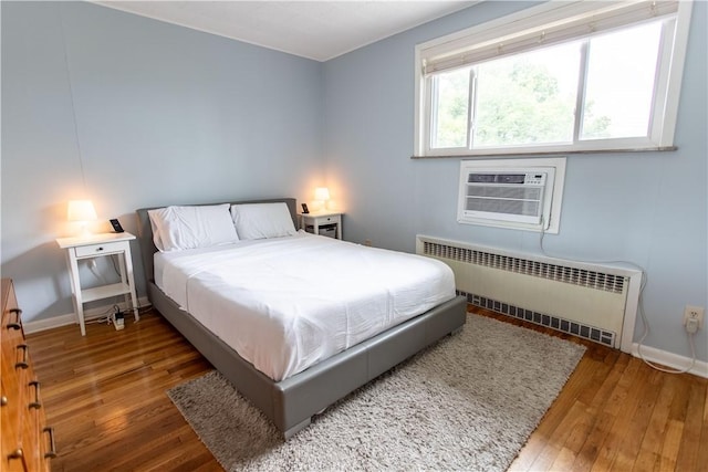 5553 Pocusset St, Squirrel Hill, PA 15217 - bedroom with radiator heating unit, wood-type flooring, and an AC wall unit
