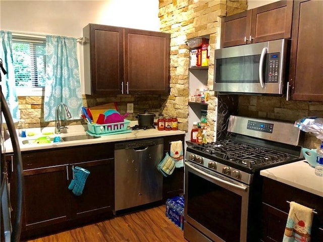 109 Watson Blvd, Perry Hilltop, PA 15214 - kitchen with stainless steel appliances, light countertops, tasteful backsplash, and wood finished floors