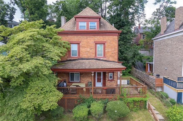 109 Watson Blvd, Perry Hilltop, PA 15214 - rear view of house featuring brick siding, a chimney, a shingled roof, and a deck