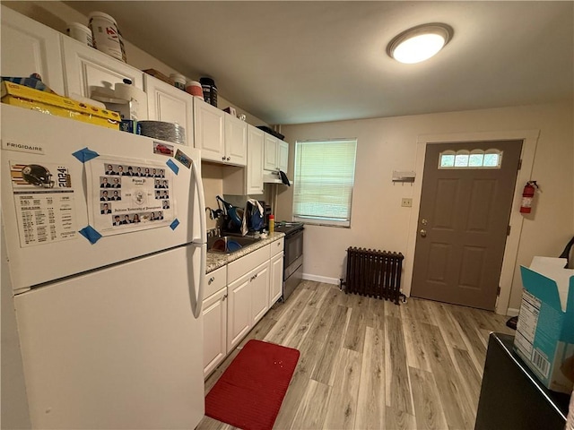 1201 Illinois Ave, Dormont, PA 15216 - kitchen featuring freestanding refrigerator, radiator, electric range, under cabinet range hood, and white cabinetry