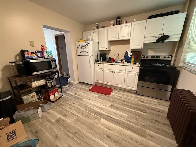 1201 Illinois Ave, Dormont, PA 15216 - kitchen featuring stainless steel appliances, under cabinet range hood, light wood finished floors, white cabinetry, and light countertops