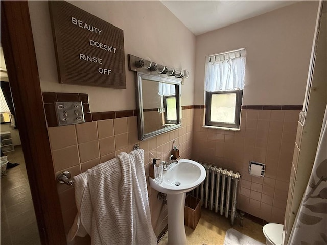 1201 Illinois Ave, Dormont, PA 15216 - bathroom featuring radiator heating unit, tile walls, and wainscoting