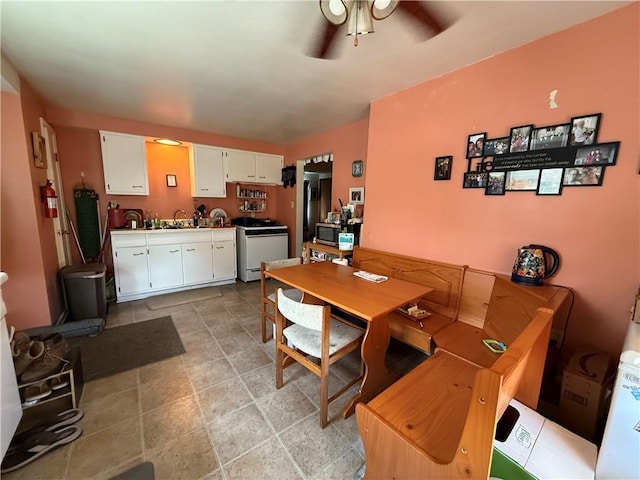 1201 Illinois Ave, Dormont, PA 15216 - dining area featuring a ceiling fan, light stone finish floors, and washer / clothes dryer