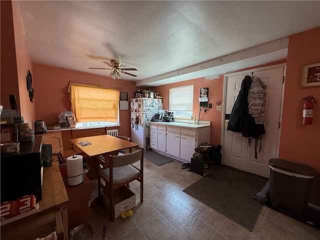 1201 Illinois Ave, Dormont, PA 15216 - kitchen featuring freestanding refrigerator, a ceiling fan, light countertops, and white cabinets