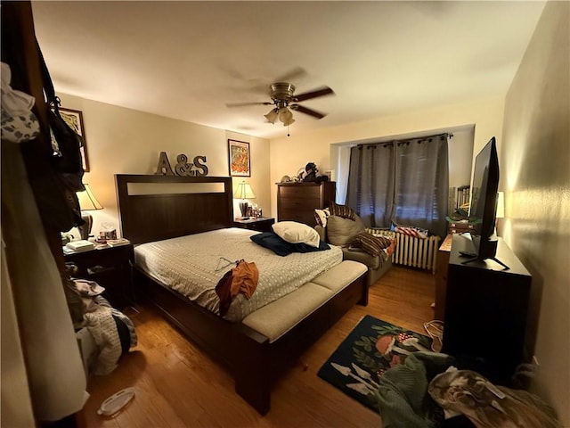 1201 Illinois Ave, Dormont, PA 15216 - bedroom with wood finished floors, ceiling fan, and radiator
