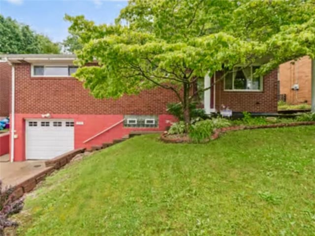 524 Greenridge Rd, New Kensington, PA 15068 - view of front of home featuring an attached garage, brick siding, a front lawn, and concrete driveway