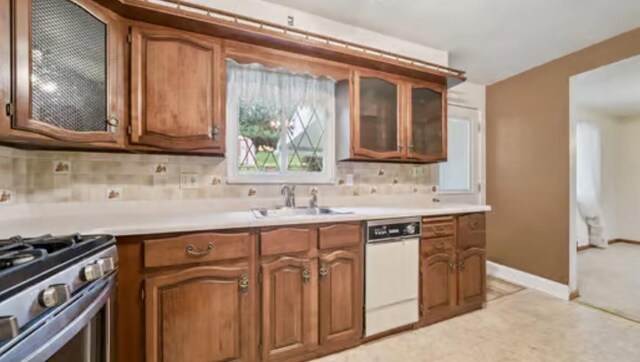 524 Greenridge Rd, New Kensington, PA 15068 - kitchen with dishwasher, brown cabinets, backsplash, and light countertops