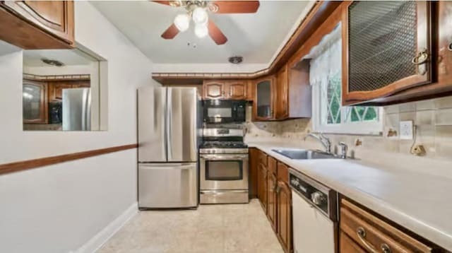 524 Greenridge Rd, New Kensington, PA 15068 - kitchen featuring appliances with stainless steel finishes, brown cabinetry, backsplash, glass insert cabinets, and a ceiling fan