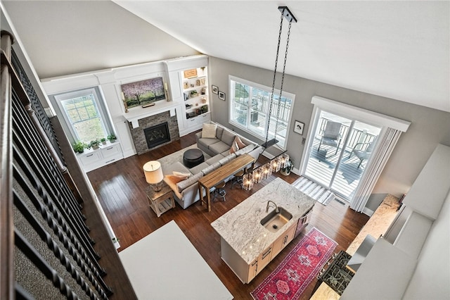 1416 Commons Ln, South Fayette, PA 15017 - living area featuring dark wood-style flooring, plenty of natural light, a fireplace, and lofted ceiling
