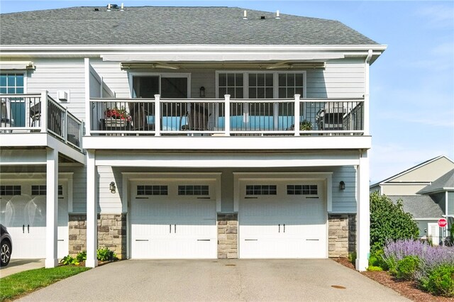1416 Commons Ln, South Fayette, PA 15017 - back of house featuring a balcony, stone siding, an attached garage, and driveway