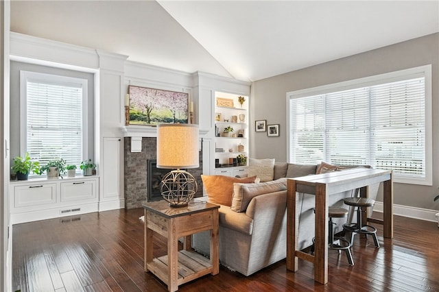 1416 Commons Ln, South Fayette, PA 15017 - living area with healthy amount of natural light, vaulted ceiling, a fireplace, and dark wood finished floors