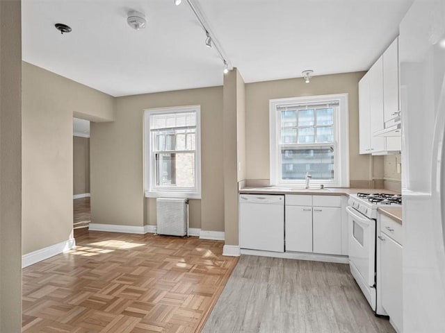 166 N Dithridge St Unit 3E, Oakland, PA 15213 - kitchen featuring white appliances, plenty of natural light, radiator, and light countertops