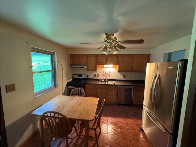 495 Pierson Run Rd, Plum Boro, PA 15239 - kitchen with appliances with stainless steel finishes, under cabinet range hood, ceiling fan, dark countertops, and tasteful backsplash