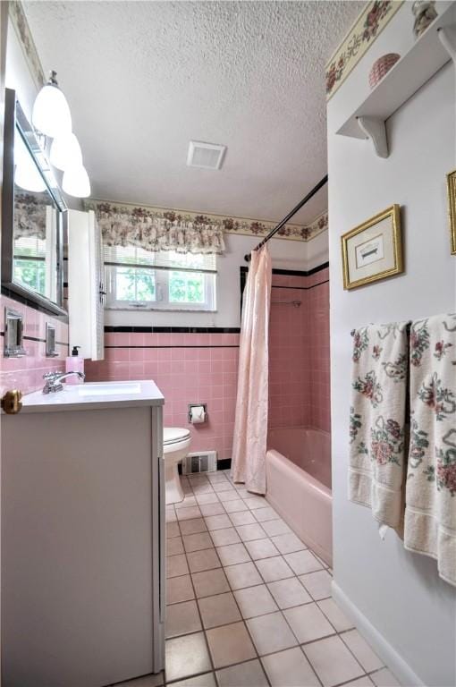 6437 Willem, Jefferson Hills, PA 15332 - full bathroom with vanity, a textured ceiling, shower / tub combo with curtain, tile patterned flooring, and tile walls