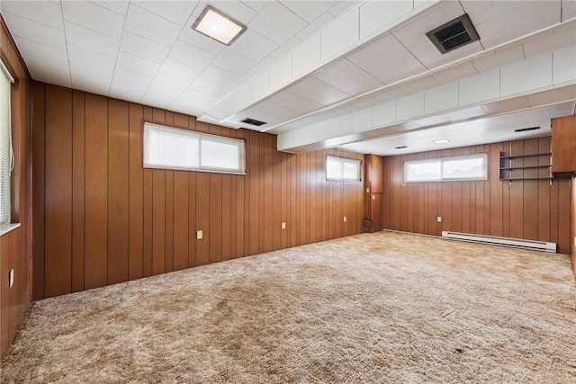 409 Westland Dr, Hempfield Twp, PA 15601 - basement featuring a baseboard radiator, carpet, and wooden walls