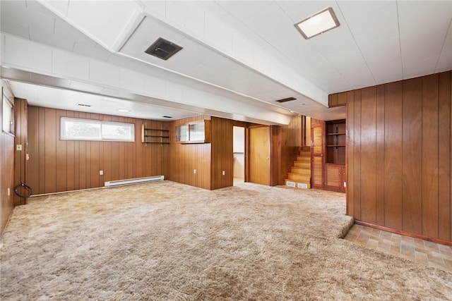 409 Westland Dr, Hempfield Twp, PA 15601 - basement featuring a baseboard heating unit, wooden walls, stairs, and carpet flooring
