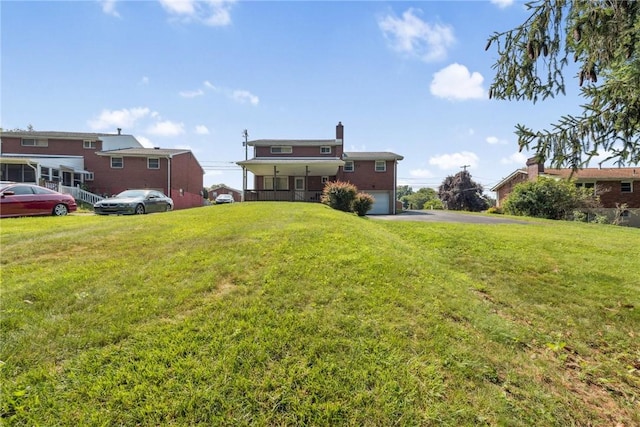 409 Westland Dr, Hempfield Twp, PA 15601 - view of green lawn featuring an attached garage and driveway