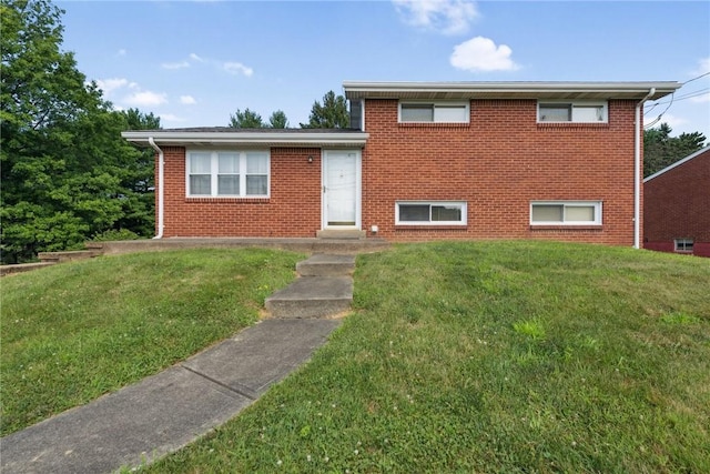 409 Westland Dr, Hempfield Twp, PA 15601 - tri-level home with a front yard and brick siding