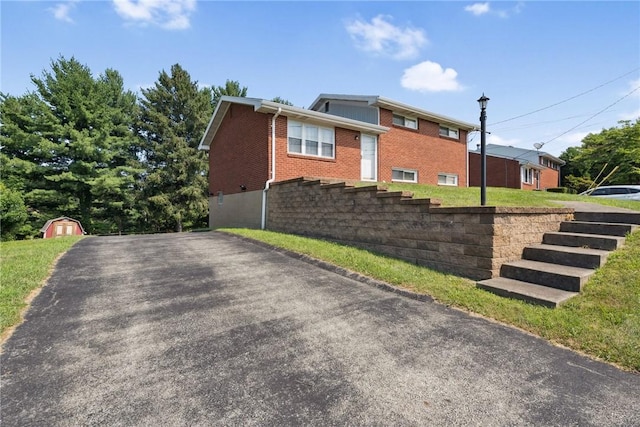 409 Westland Dr, Hempfield Twp, PA 15601 - view of side of home with brick siding and a storage shed